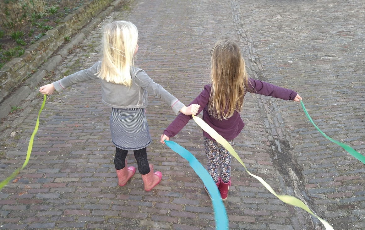 Kinderen wapperen met linten om de beweging van water na te doen. Foto Dieuwke Kloppenburg